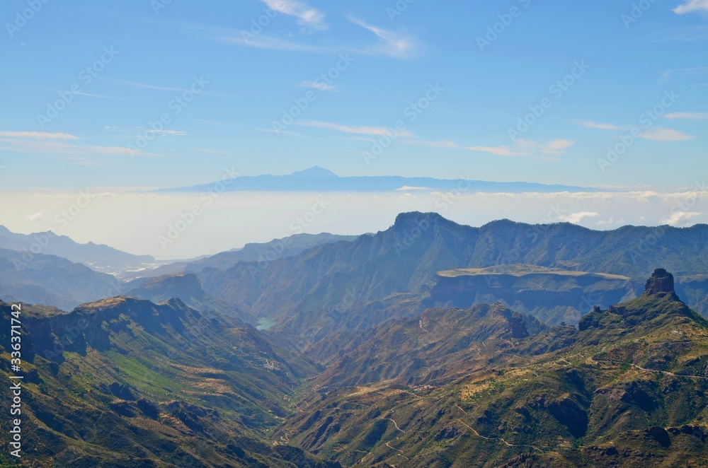 Aerial view on  Gran Canaria mountainscape towards neigbour island Tenerife with Mount Teide