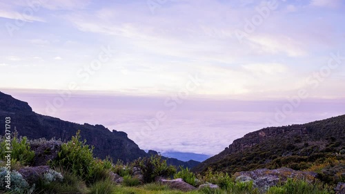 Timelapse view of Kibo with Uhuru Peak (5895m, highest mountain in Africa) at Mount Kilimanjaro, Kilimanjaro National Park. Beautiful landscape with clouds floating over the  volcano. photo