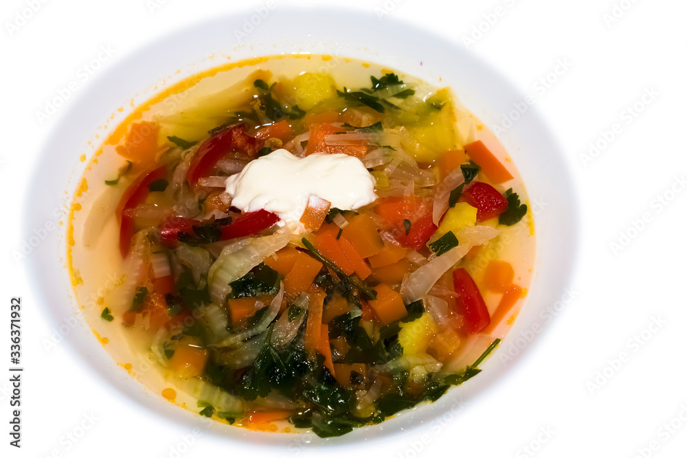Vegetable soup with sour cream on a white background.