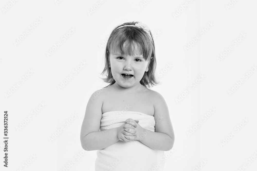 a little girl grimaces against a white background. The child is up to something. Concept of emotions , facial expressions, childhood, sincerity a little girl grimaces against a white background. The child is up to something. Concept of emotions , facial expressions, childhood, sincerity