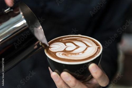 Coffee Latte Barista making pattern in a cup of coffee shop