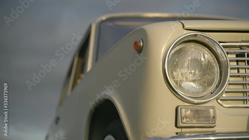 Headlight of old white vintage soviet car