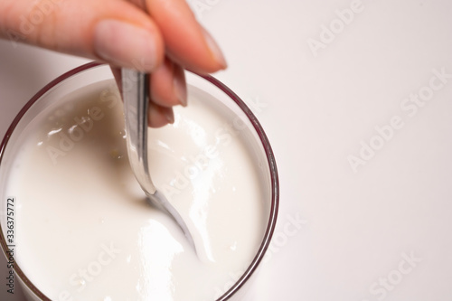 A hearty and healthy breakfast consisting of calcium and vitamins. Glass with Greek yogurt on a white background, isolated