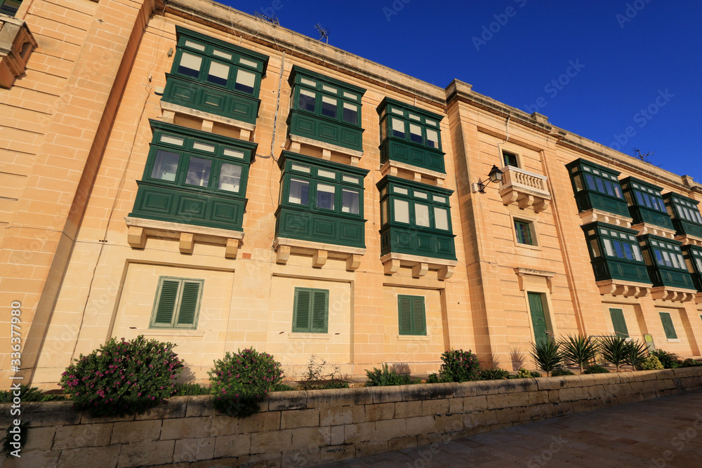Naklejka premium Exterior view of newly renovated residential houses located on top of the fortifications of Valletta, Malta, next to the famous City Gate