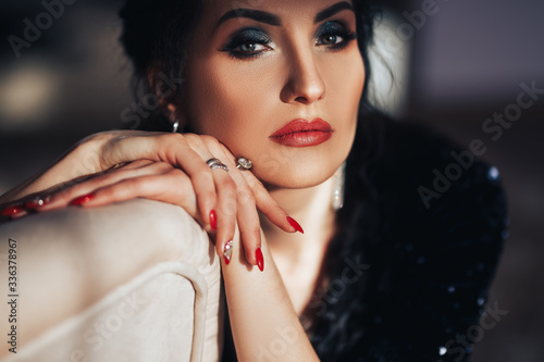 Portrait of beautiful woman with long colored black hair and bright dark make-up