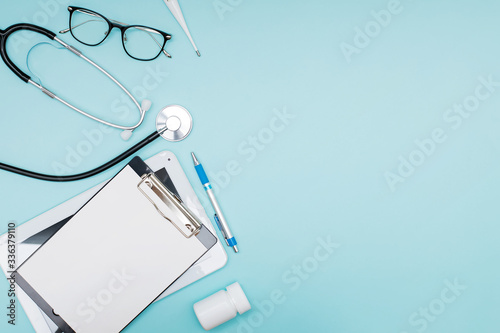 Thermometer, phonendoscope, tablets and clipboard, top view