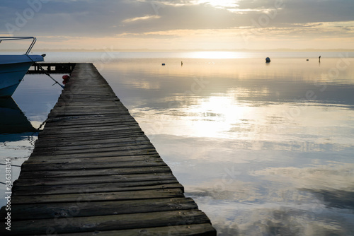 Fototapeta Naklejka Na Ścianę i Meble -  Biscarrosse lake sunset wooden ponton on water for boat fishing