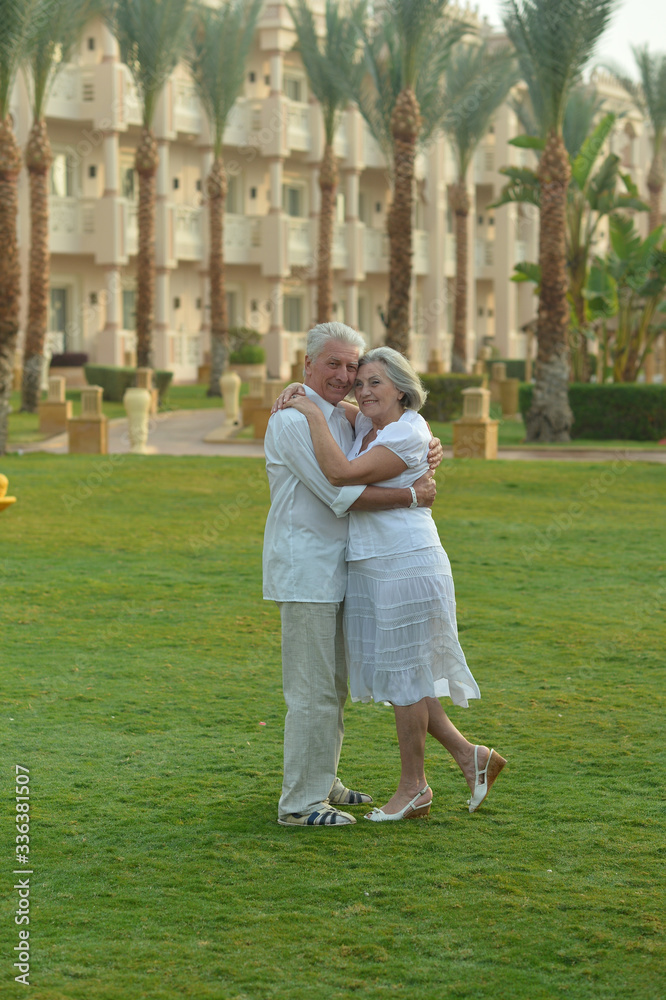 Happy senior couple at hotel resort posing