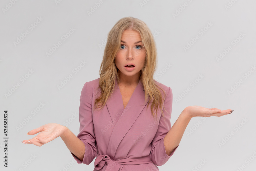 Studio portrait of cute puzzled hesitant young woman shrugs shoulders, does not know what happened. Pretty attractive woman doubting isolated on gray background Studio portrait of cute puzzled hesitant young woman shrugs shoulders, does not know what happened. Pretty attractive woman doubting isolated on gray background