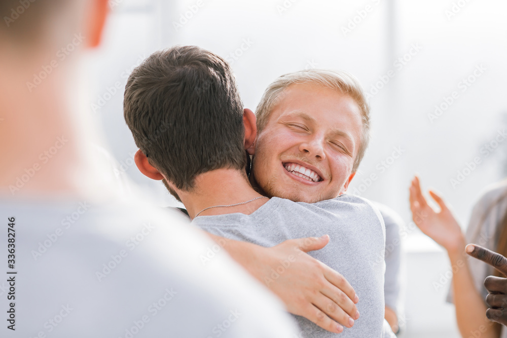 close up. happy contestants hugging each other.