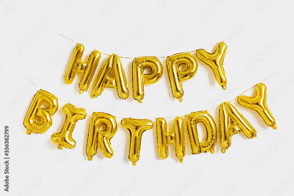 Happy birthday lettering made of golden balloons on a white background.