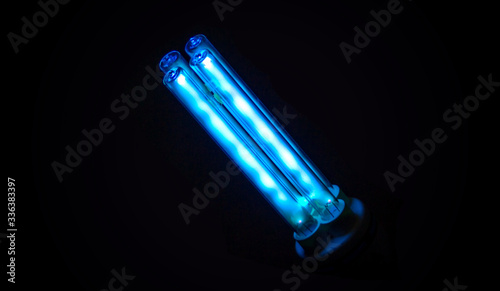 Ultraviolet lamp  emitting UV-C light in the dark. photo
