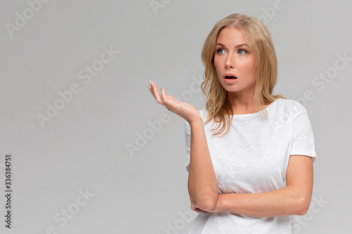 Wtf are you talking about. Portrait of displeased pissed european female, standing in angry pose, shaking hands and gesturing, being clueless and questioned, standing puzzled over grey wall