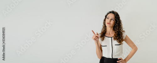 mujer blanca señalando con el dedo pensando en una idea ingeniosa