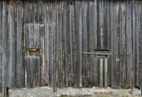 Old wooden wall. Brown boards with crumbling texture