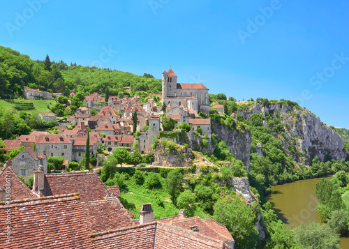 Landscape view of Saint-Cirq-Lapopie, one of the most beautiful villages in France (Les Plus Beaux Villages de France), located on a cliff over the Lot River valley, Causses du Quercy Natural Park photo