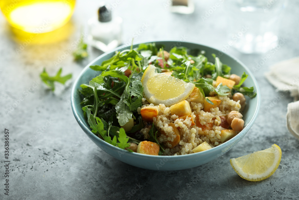 Healthy quinoa bowl with chickpea, cheese and arugula