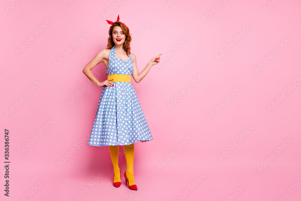 Fototapeta premium Full length photo of astonished lady promoter point index finger copyspace impressed by incredible discount scream wow omg wear blue headband yellow stockings isolated pink color background