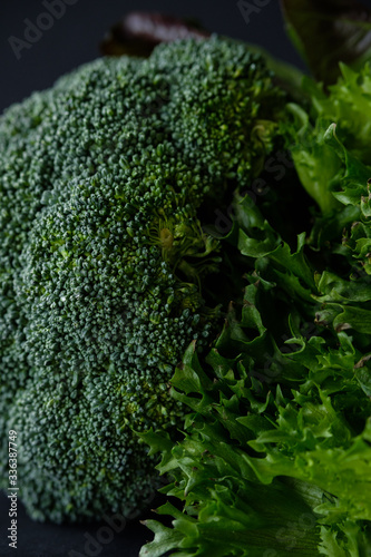 Green broccoli on a black background. Fresh greens © sipcrew