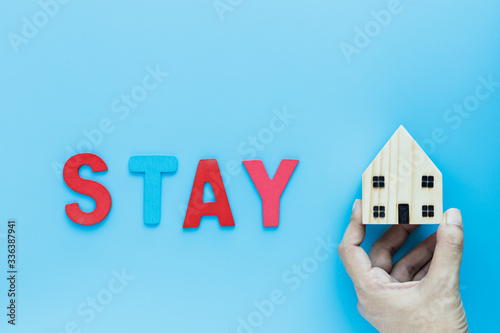 Hand holding wooden house m...