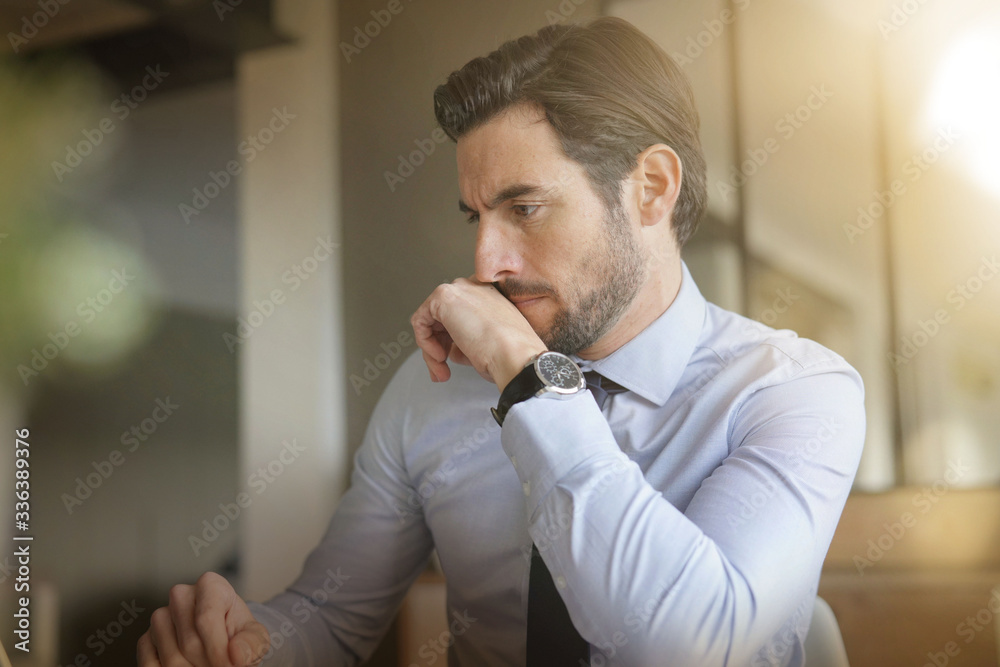 © goodluz - boss in home confinement working on his laptop