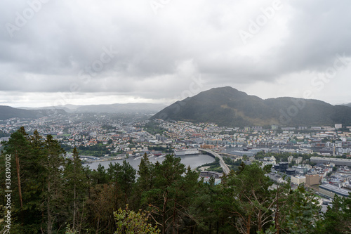 Panoramic view of Bergen from Floyen Mountain in August 2019. Trees in front of the city photo