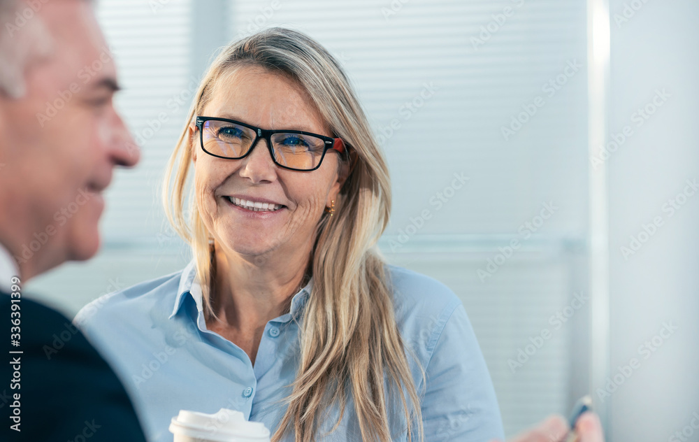 close up. businessman and businesswoman talking standing in the office. close up. businessman and businesswoman talking standing in the office.