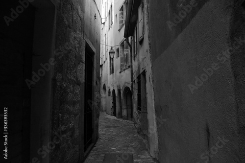 narrow street in the old town  with a vintage lamp.