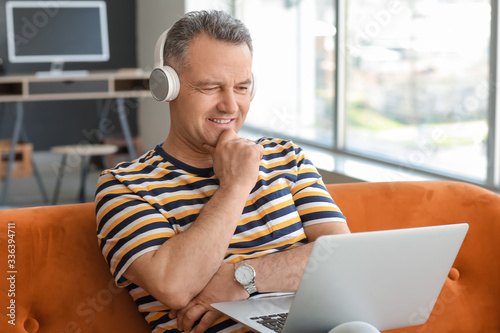 Mature man with laptop and ...