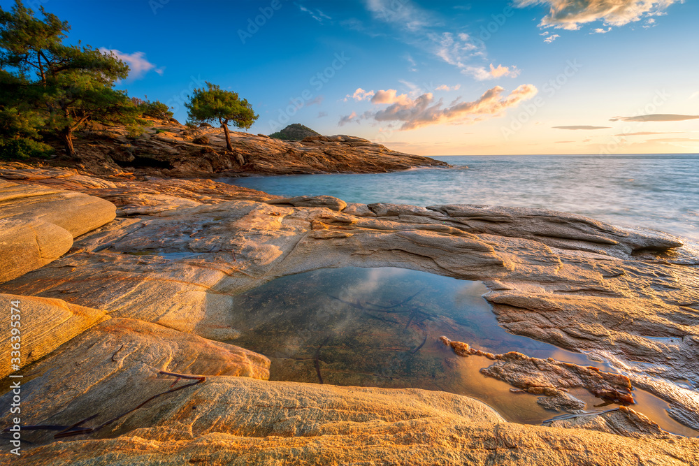 Magnificent sunset view with beautiful reflections at the rocky coastline of Thasos island, Greece