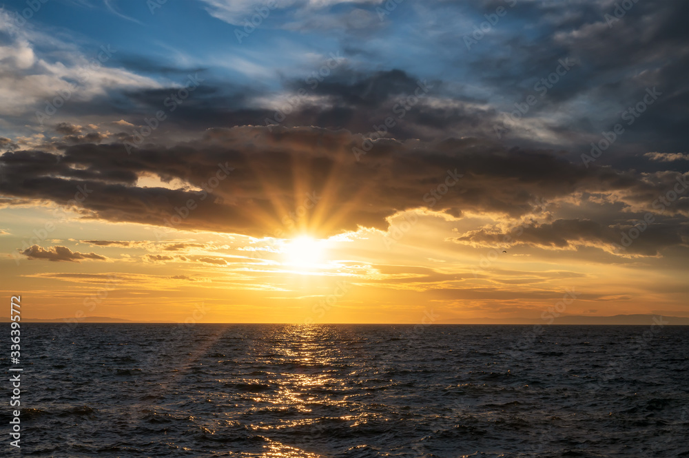 Amazing landscape with sun rays touching the waters of the Aegean sea at sunset Amazing landscape with sun rays touching the waters of the Aegean sea at sunset