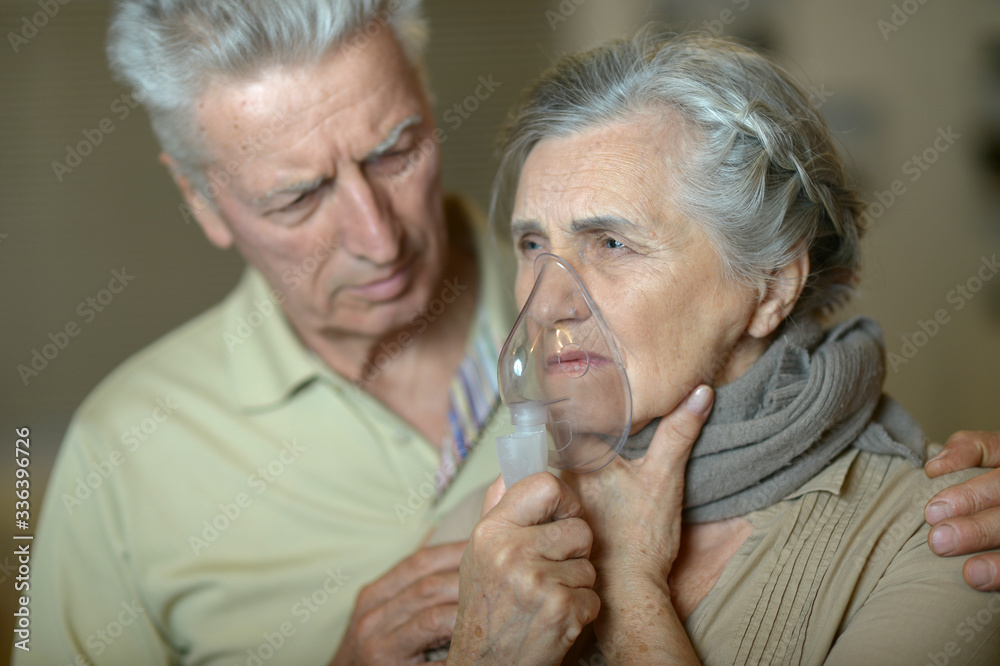 Portrait of an elder couple making inhalation Portrait of an elder couple making inhalation