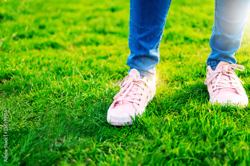 Young beautiful women girl walking forward relax fresh air in park wear pink sneaker shoes. Sightseeing solo travel holiday vacation outdoor in summer during coronavirus social distancing quarantine © Chan2545
