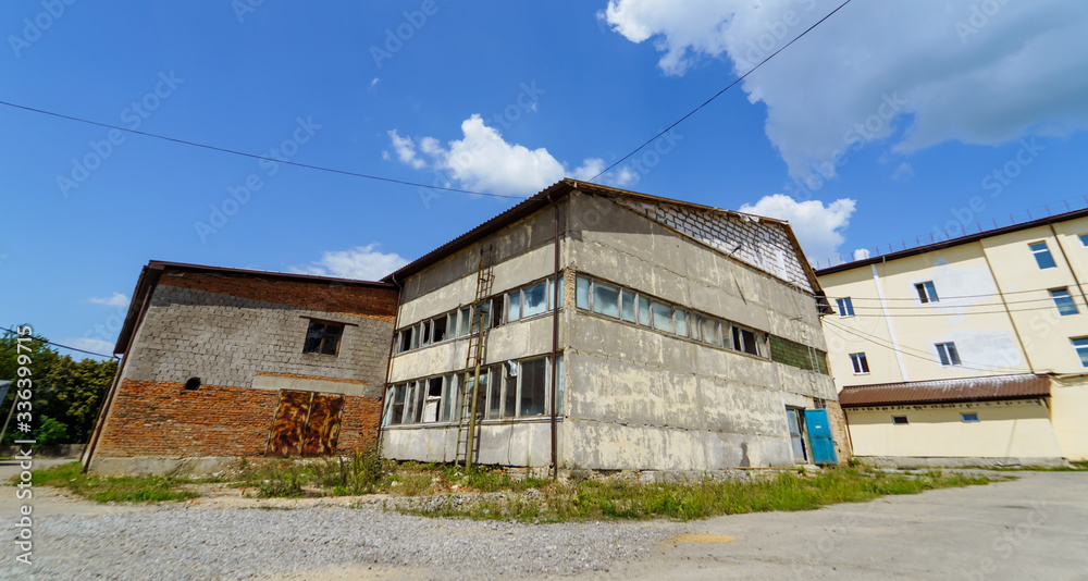 Abandoned building in the countryside on a sunny day. Rustic storehouse.
