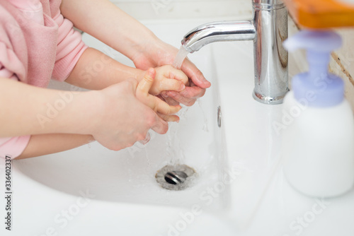 Children wash their hands with disinfectant foam to maintain health and kill viruses.