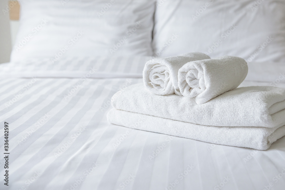 Freshly laundered fluffy towels on bed in hotel Freshly laundered fluffy towels on bed in hotel