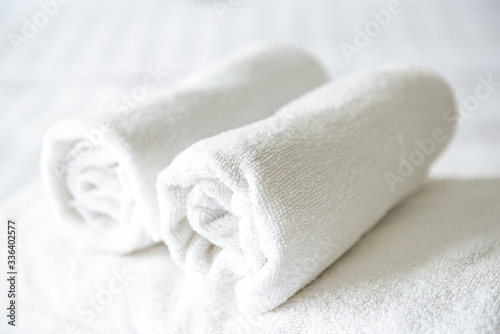 Freshly laundered fluffy towels on bed in hotel