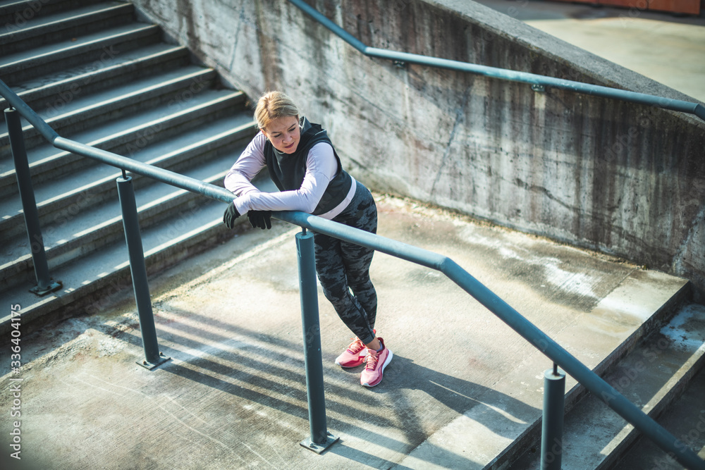 Young Caucasian woman taking a break after running