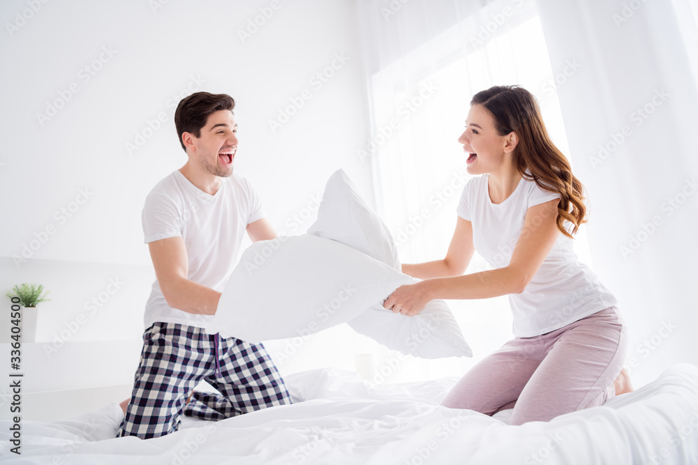 Photo of crazy funny lady cheerful handsome guy married couple in love playing pillow fight sheets bed enjoy weekend saturday morning good excited mood wear pajama room indoors Photo of crazy funny lady cheerful handsome guy married couple in love playing pillow fight sheets bed enjoy weekend saturday morning good excited mood wear pajama room indoors