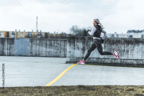 Young Caucasian woman in a running pose