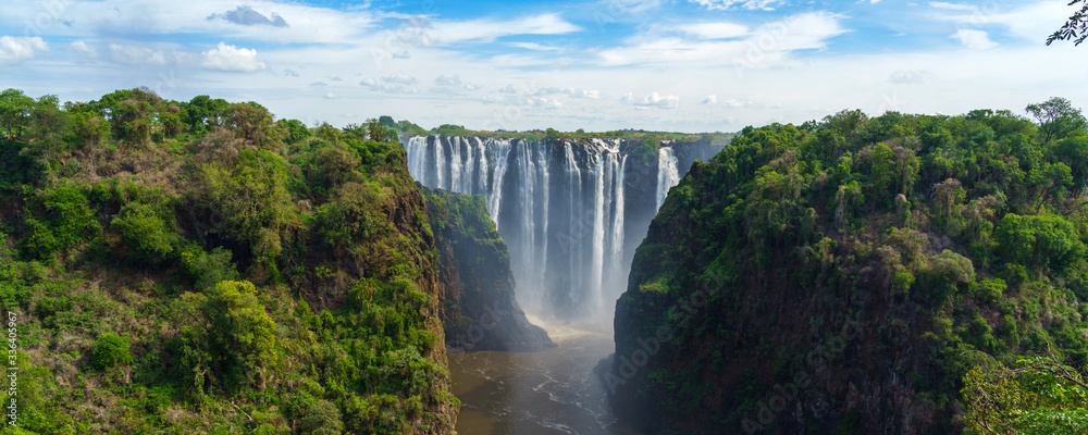 Panorama view with dramatic waterfall and clouds at Victoria Falls, Zambezi River, Zimbabwe, Zambia. - obrazy, fototapety, plakaty 