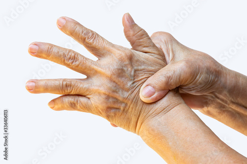 Trigger Finger, Senior woman's right hand massaging her left hand Suffering from pain on white background, Close up & Macro shot, Office syndrome, Healthcare, Massage, Asian body concept photo