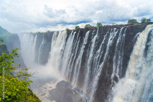 Panorama view to the dramatic waterfall and clouds at Victoria Falls on the Zambezi River, Zimbabwe, Zambia.