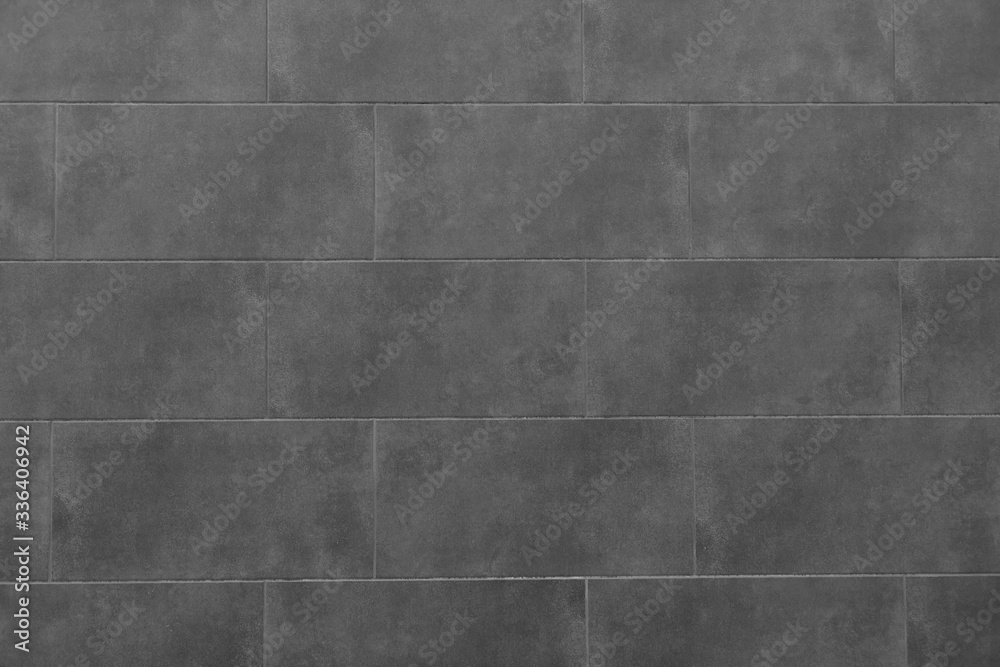 The texture of the black tile wall. Background of black tiled wall