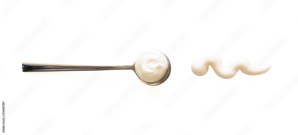 Spoon with mayonnaise and sauce splash isolated on white background, top view. Close-up seasoning and dip