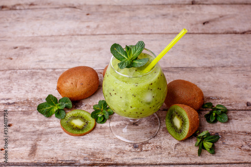 cocktail of fresh kiwi and mint in a glass glass on a wooden background
