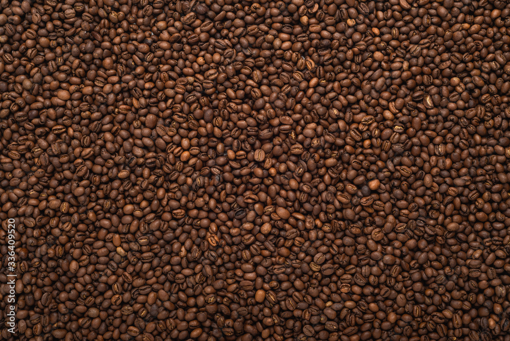 Fresh roasted coffee beans background, top view