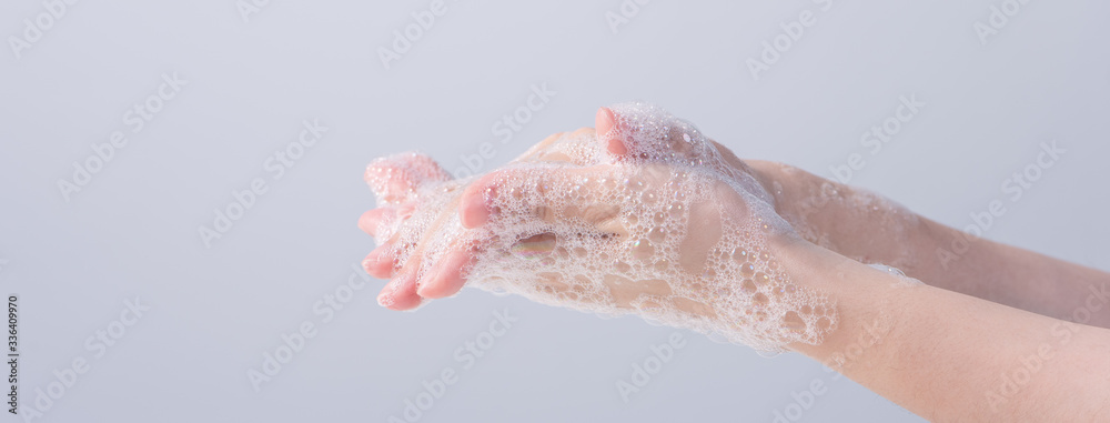 Washing hands. Asian young woman using liquid soap to wash hands, concept of hygiene to protective pandemic coronavirus isolated on gray white background, close up. Washing hands. Asian young woman using liquid soap to wash hands, concept of hygiene to protective pandemic coronavirus isolated on gray white background, close up.