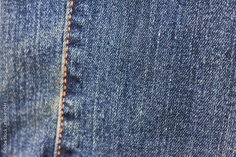 Denim blue jeans seam close up detailed view. Stitch pattern on classic denim fabric texture, modern fashion jeans cloth design with seams, closeup top view Denim blue jeans seam close up detailed view. Stitch pattern on classic denim fabric texture, modern fashion jeans cloth design with seams, closeup top view
