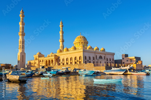 Mosque with fishing boats at sea in egypt photo